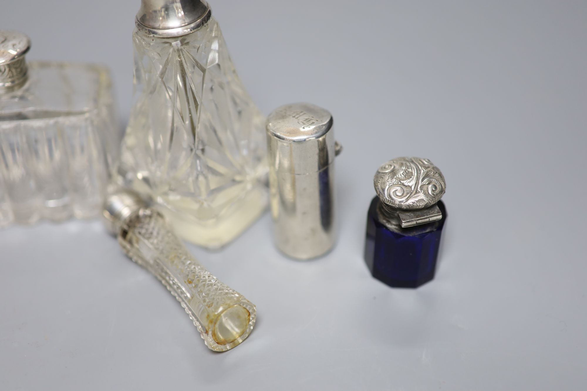 A Victorian cylindrical silver scent bottle by Sampson Mordan & Co, London, 1882, 54mm (a.f.), 8 others and a vest case.